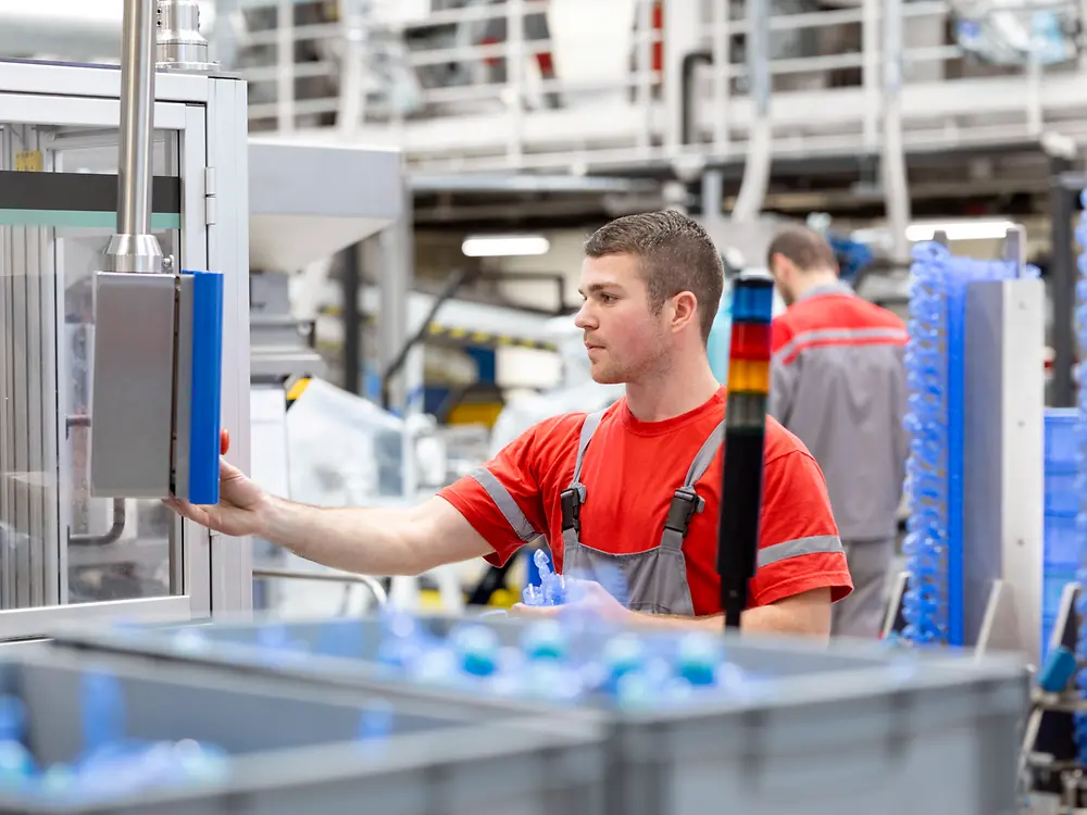 An employee operating a production machine in the Henkel plant in Kruševac, Serbia