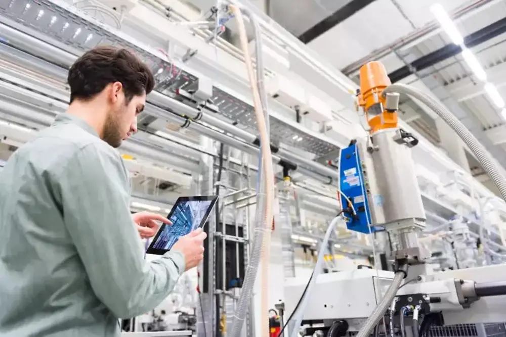 Man with a tablet in a production site